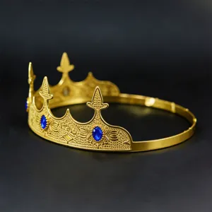 Close-up detail shot of vintage gold crown with blue gems for party king headwear decor.