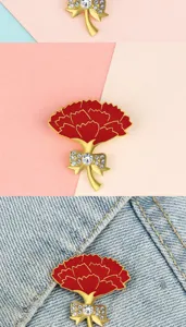 Red carnation flower brooch detail view, metal rhinestone bow accessory for women's suit.