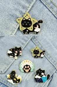 Enamel black cat brooch pins set with celestial moon and star details for cute sweater wear.