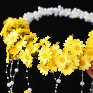 Detailed view of yellow daisy floral headband with elegant white pearl fringe tassels for events.