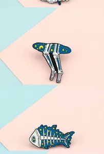 Creative starry skeleton fish enamel pin detailed view, trendy cute metal badge decor.