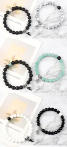 Detailed view of couple magnetic beaded bracelets featuring stone beads and heart clasp charms.