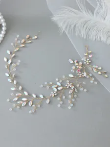 Close-up detail of bridal crystal vine hair band with iridescent rhinestones and gold wire.