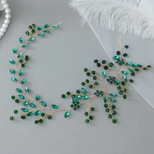 Close-up detail of the green crystal rhinestone vine hairband, showing exquisite handmade work.
