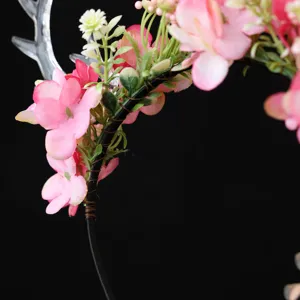 Close-up detail of the forest style pink flower reindeer antler headband for holiday.