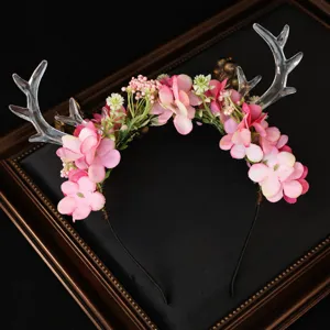 Forest style deer antler flower headband with pink floral and clear resin antlers for festival.