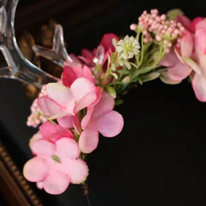 Close-up detail of forest style pink floral antler headband, sweet festival hair accessory.