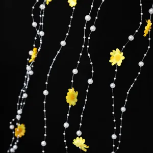 Detail shot of artificial daisy flowers and pearl tassel string for wedding bridal hair styling.