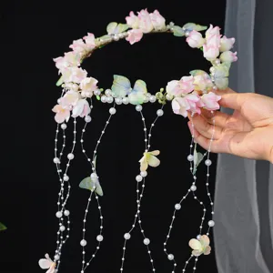 Handmade butterfly floral crown with faux pearl tassels, perfect bridal hair accessory.