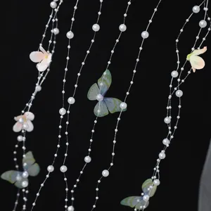 Close up view of handmade pearl strings and butterfly hair accessory detail design