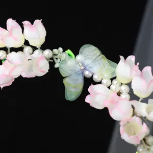 Close-up detail of handmade pearl butterfly flower hair garland, exquisite rhinestone embellishment.
