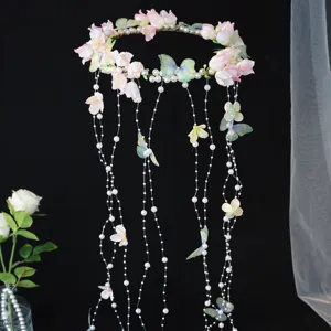 Close-up detail of the handmade butterfly floral headband featuring delicate pearls and flowing tassels.