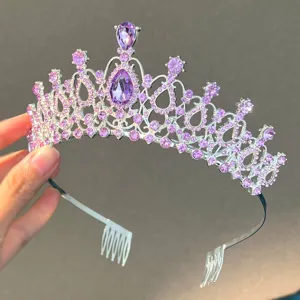 Close-up detail of silver crystal tiara with purple rhinestones and side comb for bridal.