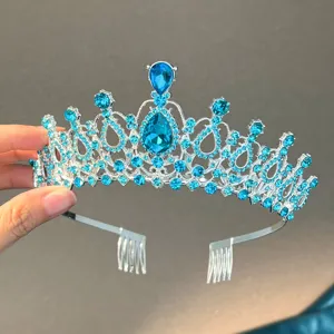 Close-up detail of blue rhinestone bridal tiara crown with hair combs for wedding and party hair.