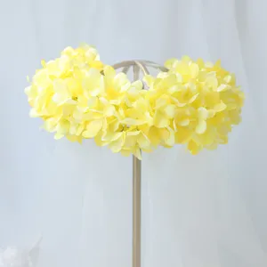 Detailed view of yellow artificial hydrangea flower crown bridal headband with veil