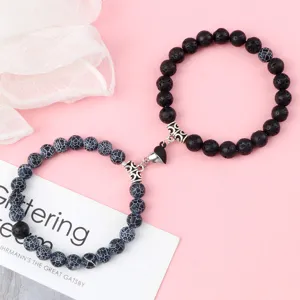 Magnetic couple bracelets set with lava stone and cracked agate featuring heart magnetic clasp.