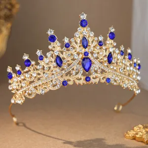 Stunning gold bridal tiara with sparkling blue and clear rhinestones for gorgeous wedding decor.