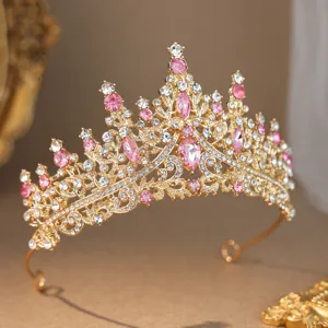 Gold tiara detail shot featuring sparkling pink and clear rhinestones for bridal elegance.