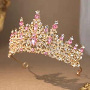 Detailed view of luxury gold rhinestone princess crown bridal tiara with pink and white gems.