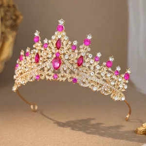 Close-up detail of luxury gold rhinestone tiara with sparkling pink and clear crystals.