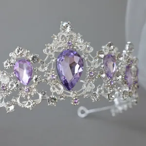Detailed closeup of silver tiara with purple teardrop crystals, sparkling bridal hair accessory.