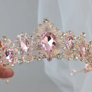 Close-up detail of a stunning rose gold tiara featuring sparkling pink crystal rhinestones.