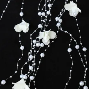 Handmade pearl flower fringe hair accessory detail shot for wedding dress and forest style.