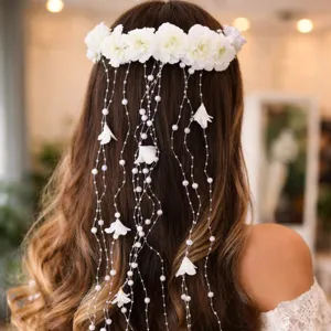 Close-up detail of bridal floral crown with pearl tassels, elegant wedding hair accessory.