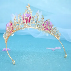 Detailed view of the ocean-inspired gold princess tiara crown with pink accents for events.