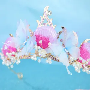 Close-up detail of ocean style butterfly seashell tiara rhinestone crown hair accessory.