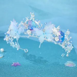 Detail view of the ocean-inspired crystal tiara headband with blue butterfly and shell accents.