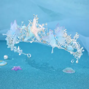Ocean style crown detail showing the rhinestone starfish and blue butterfly hair accessory.
