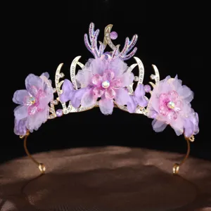 Detail view of handmade purple flower mesh butterfly tiara princess crown hair band.
