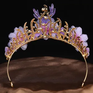 Close-up detail of the gold metal tiara featuring purple mesh flowers and deer antler decor.