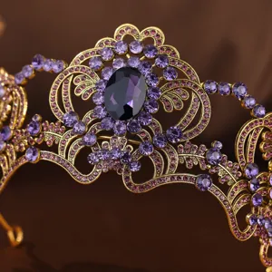 Close-up detail of vintage gold-plated tiara featuring sparkling purple and pink rhinestones.