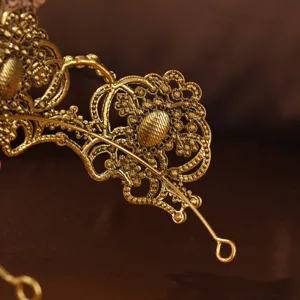 Retro gold metallic filigree crown hair accessory, exquisite vintage bridal tiara detail.