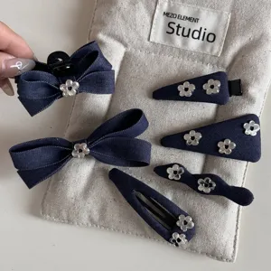 Denim blue bow hair clip set featuring cute silver flower charms and multiple hair accessories.