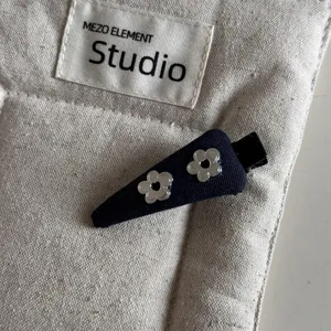 Denim blue hair clip with cute silver metal flower design, elegant mini duckbill clip for women.
