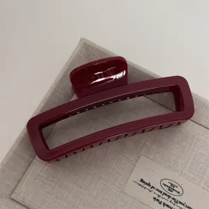 Red rectangular hair claw clip, elegant large geometric hair accessory for women styling daily wear.