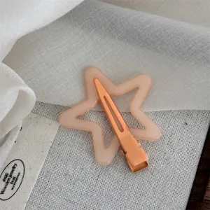 Close-up of cute orange hollow star hair clip with duckbill design for sweet daily hairstyles.