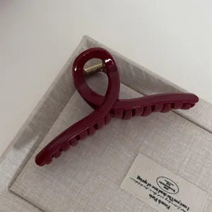 Red hair claw clip detail, stylish hair accessory for women, elegant daily wear design.