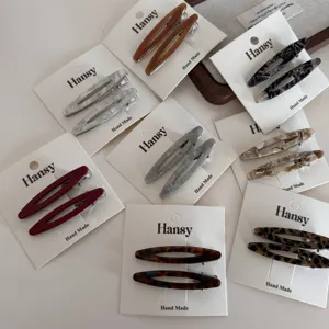 Minimalist marble pattern oval duckbill hair clips, stylish side fringe clips for women details.