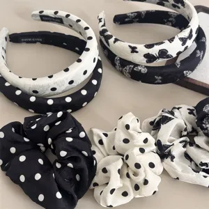 Detail view of black and white polka dot and butterfly print sponge headband and scrunchie set.