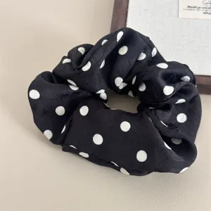 Classic black and white polka dot hair scrunchie, elegant silk-like fabric hair accessory for daily wear.