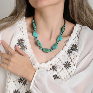 Close-up detail shot of retro artistic irregular turquoise beaded necklace for women.