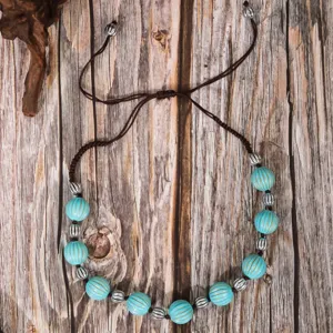Detailed view of the retro handmade turquoise-style beaded necklace with adjustable braided cord.