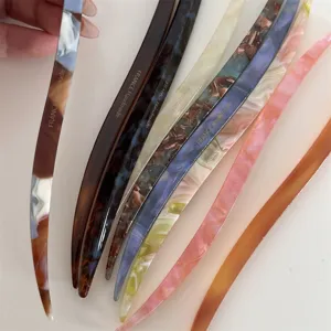 Detailed view of colorful handmade acetate hair sticks, elegant hair pins for stylish updos.