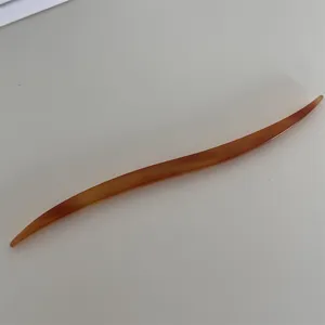 Elegant cellulose acetate hair stick, smooth curved design for chic french twist and buns.