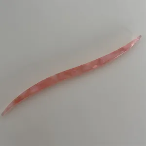 Pink acetate hair stick with streamline design for sweet bun styling and hair accessories.