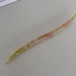 Sweet candy color acetate hair stick detail view, elegant hairpin for lazy hairstyles and buns.